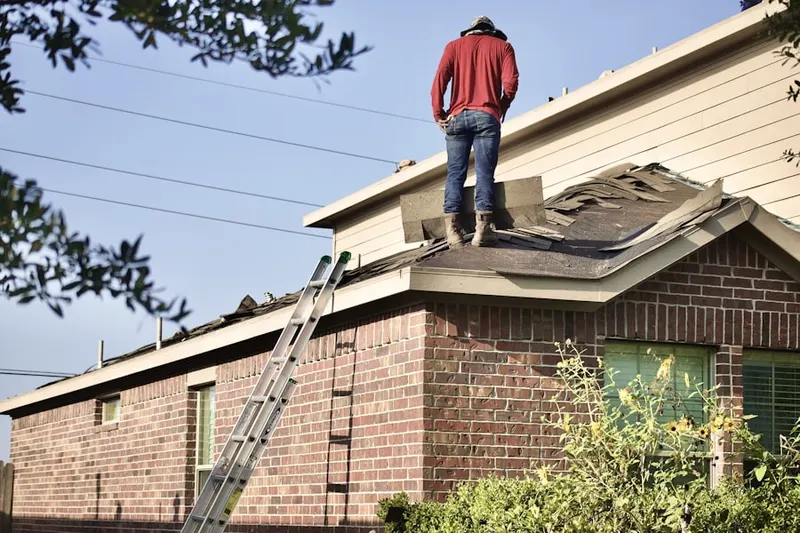 Professional roofer working on a residential roof in Annetta South